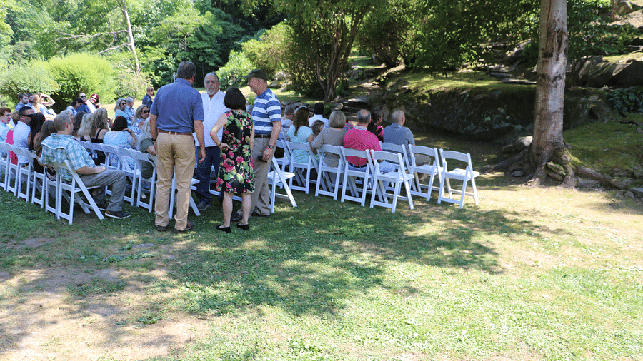 a crowd sitting facing towards the trees surrounded by lush greenery - Historic Tapoco Lodge