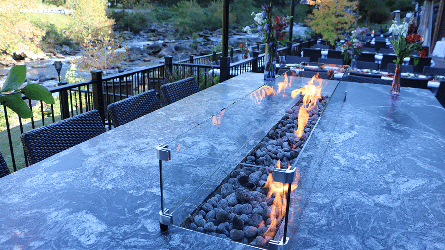 IMG 8678close up image of the marble dining table featuring the stone fire pit in protected by tempered glass - Historic Tapoco Lodge