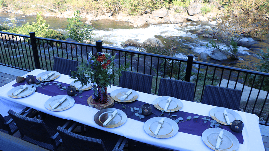 top angle view of neatly decorated dining area featuring a flower vase and beautiful crockery - Historic Tapoco Lodge
