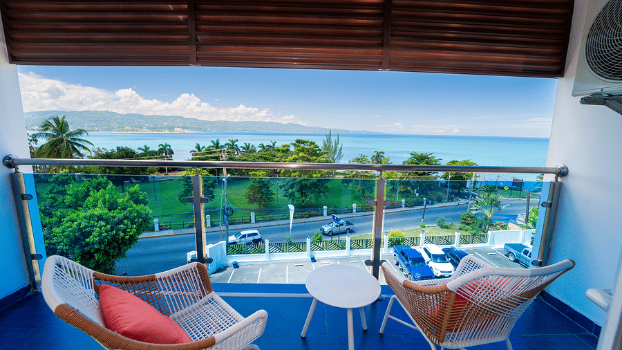 An image of a balcony in our Montego Bay hotel room that opens to the view of the coast of Montego Bay - Hotel 39, Jamaica (Montego Bay).