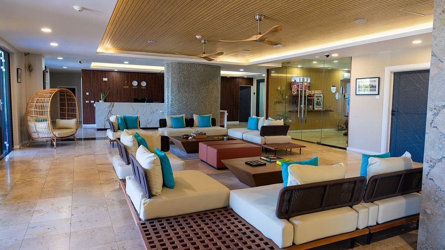 An overview of a hotel lobby in Montego Bay featuring ambient lighting, cosy and contemporary looking sofas placed around a table - Hotel 39, Jamaica (Montego Bay)