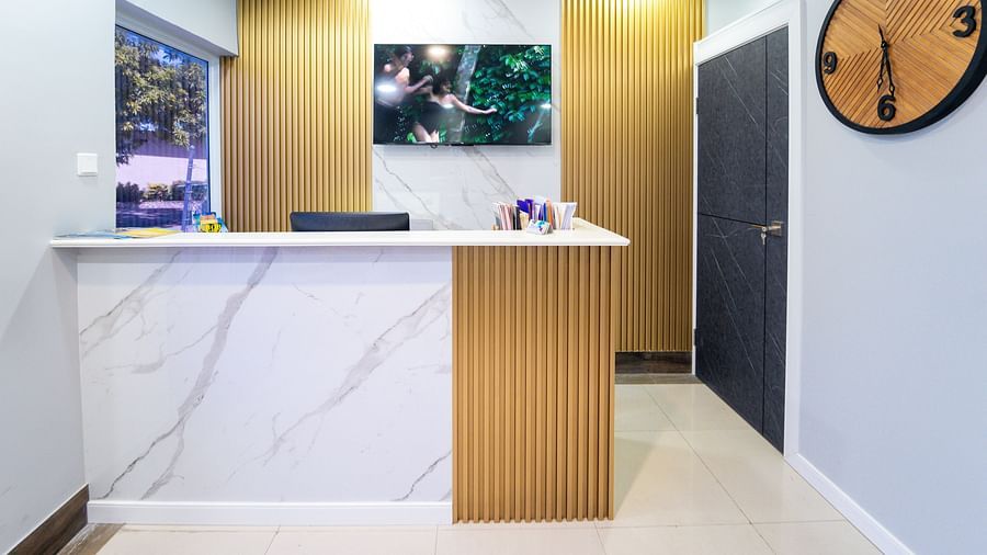 An image of a reception desk in a travel agency with a wall-mounted clock on the side - Hotel 39, Jamaica (Montego Bay)