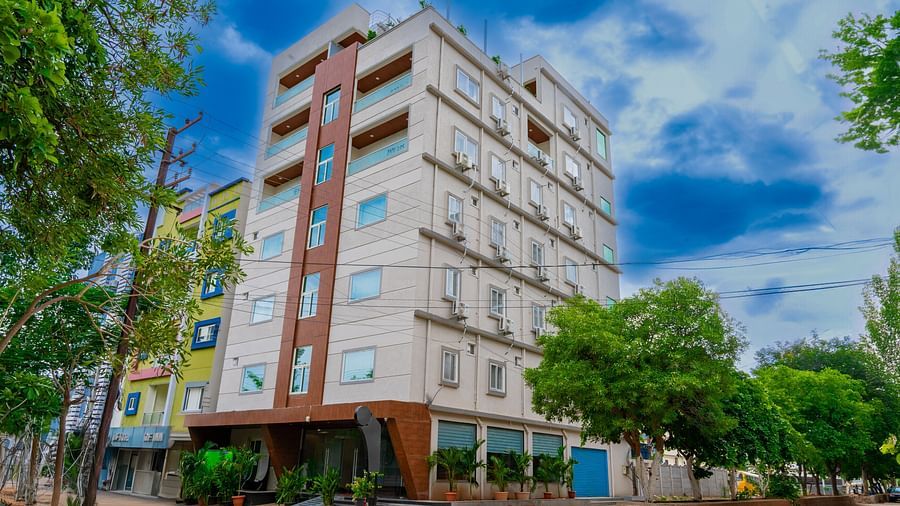 A facade image of a building surrounded by trees and plants - Hotel Aerotel, Hyderabad - A Unit of Comfort Hometel