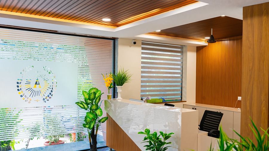 An image f a reception area that has a high desk and a chair near it - Hotel Aerotel, Hyderabad - A Unit of Comfort Hometel