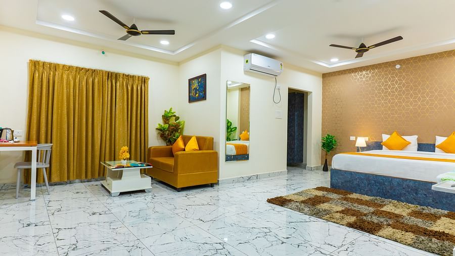 An image of a Suite with sitting area, a king size, AC, fan, etc. Hotel Aerotel, Hyderabad - A Unit of Comfort Hometel