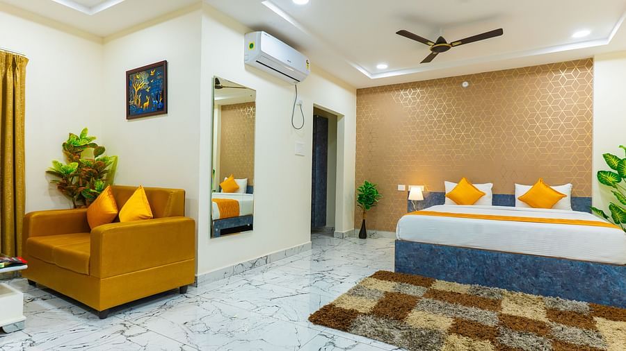 An image of a Suite with sitting area, a king size, AC, fan, etc. Hotel Aerotel, Hyderabad - A Unit of Comfort Hometel