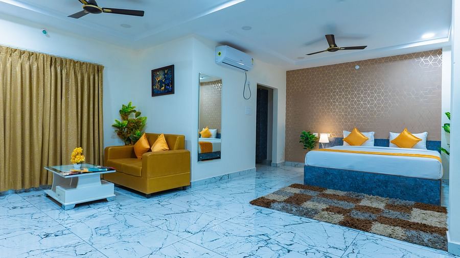 An image of a Suite with sitting area, a king size, AC, fan, etc. Hotel Aerotel, Hyderabad - A Unit of Comfort Hometel