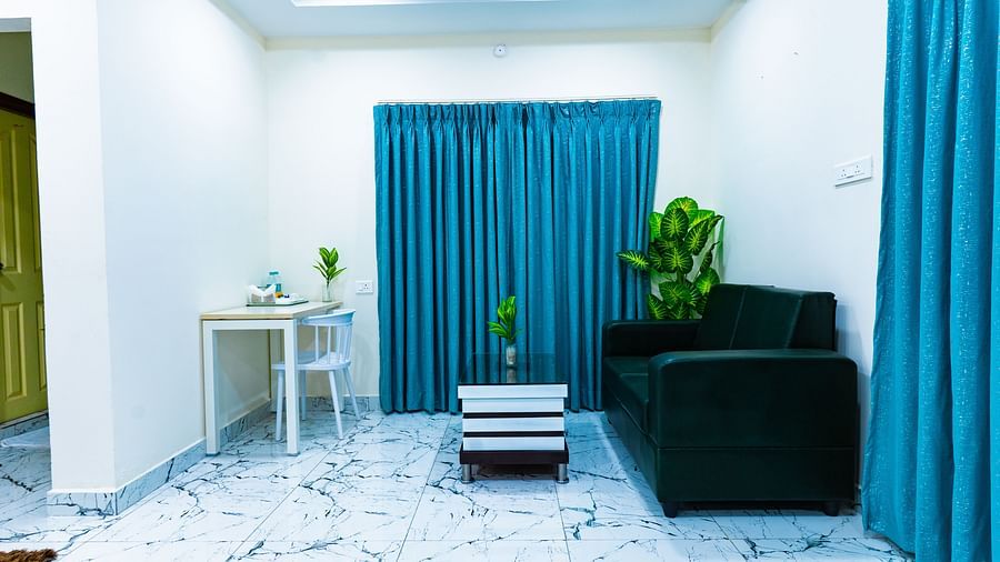 An image of a room which has a sofa and  centre table and window - Hotel Aerotel, Hyderabad - A Unit of Comfort Hometel