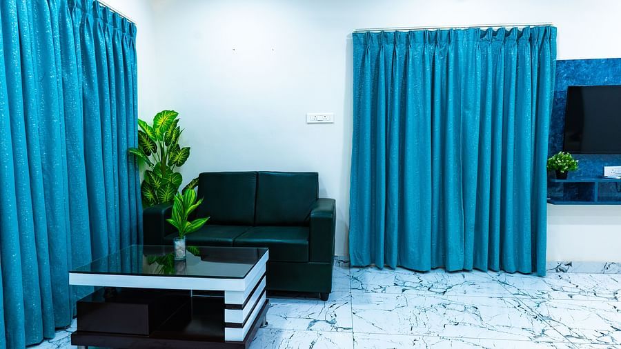 An image of a room which has a sofa and  centre table and window - Hotel Aerotel, Hyderabad - A Unit of Comfort Hometel