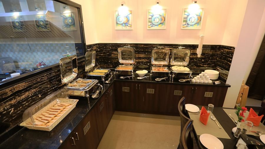 Image of a buffet table with food placed on it at Hotel Altitude, Madikeri.