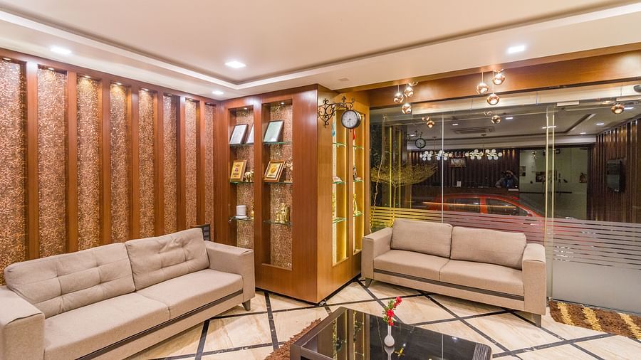 Image of a seating area with sofas and a table in between at Hotel Altitude, Madikeri.