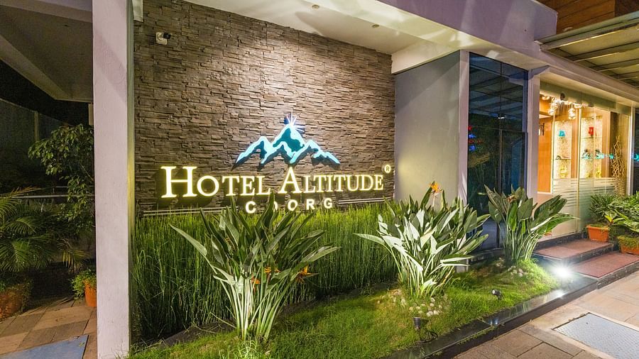 Image of a wall with Hotel Altitude written on it at Hotel Altitude, Madikeri.