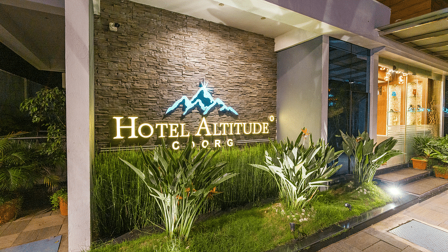 A wall with Hotel Altitude written on it at Hotel Altitude, Madikeri.