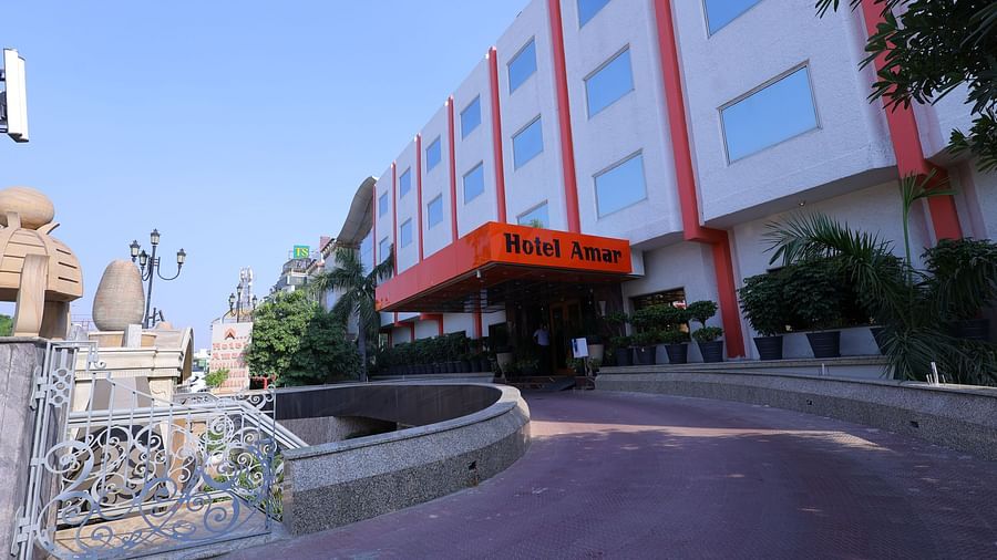 Image of exterior of a hotel building with Hotel Amar written on it