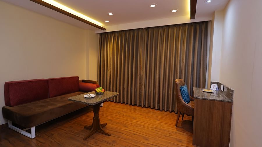 Image of a Suite at Amar Hotel with a sofa, table, and a chair