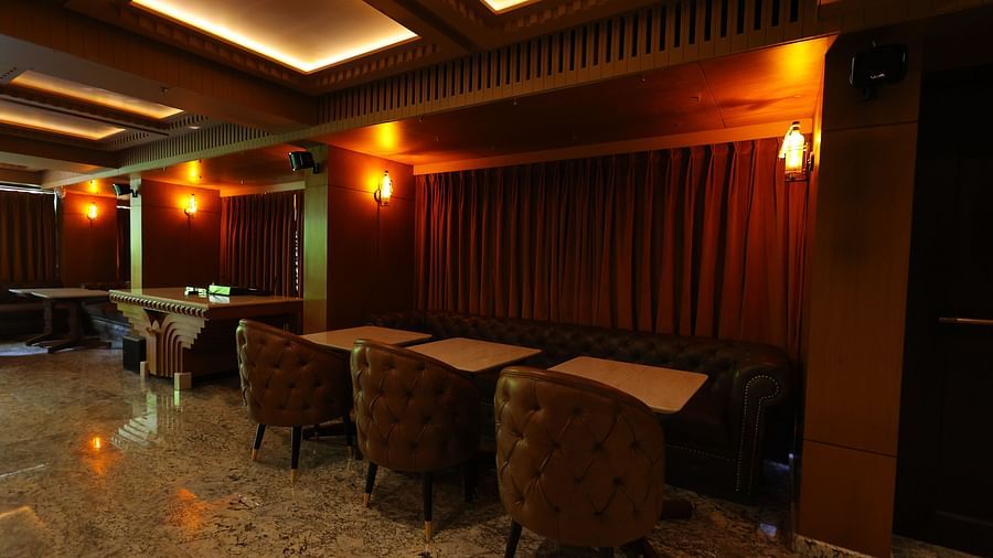 Side view image of seating area of JBs lounge at Hotel Amar with dim lighting