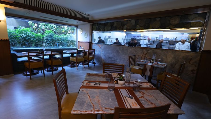 Image of Anam restaurant of Hotel Amar with chairs and tables arranged 