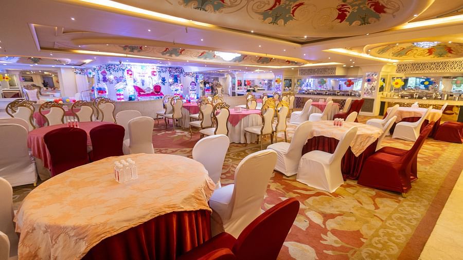 Samrat featuring round tables draped with tablecloths, some in light colours and others in a darker shade.