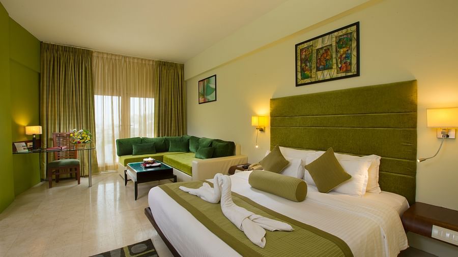 Family suite featuring a bed, a sofa and recliner at Hotel Atithi - TGI Grand, Pondicherry