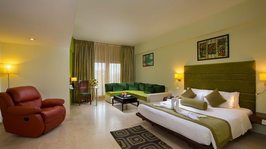 Family suite featuring a bed, a sofa and recliner at Hotel Atithi - TGI Grand, Pondicherry