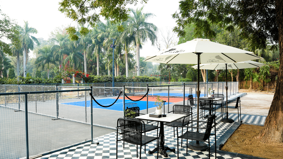 Relaxed seating setup overlooking the pickleball court at Hotel Clarks Shiraz, Agra.