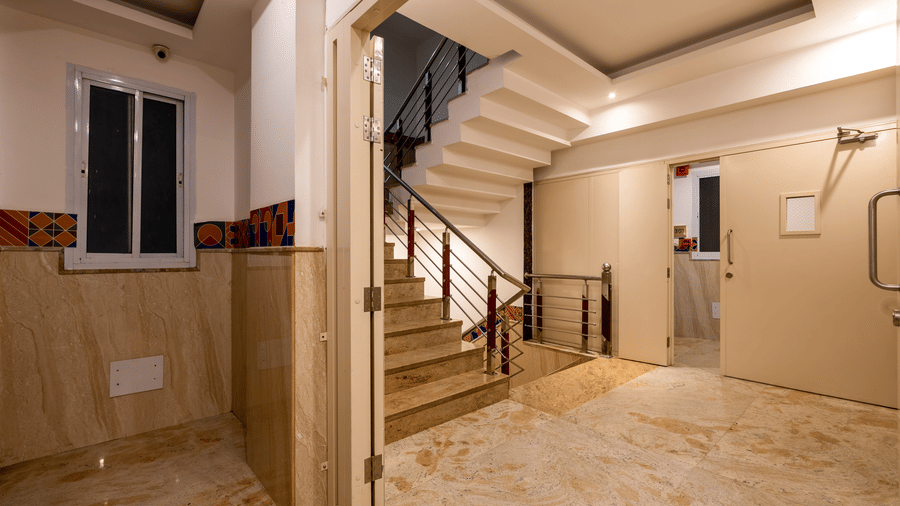 Foyer at Hotel Corporate Suites featuring a staircase with ambient lighting