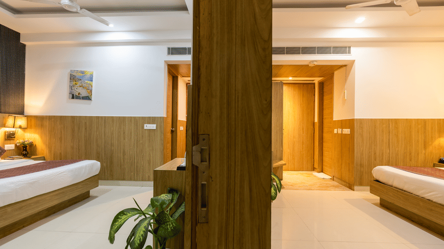 Interconnected Family Room at Hotel Corporate Suites featuring 2 bedrooms separated by a wall