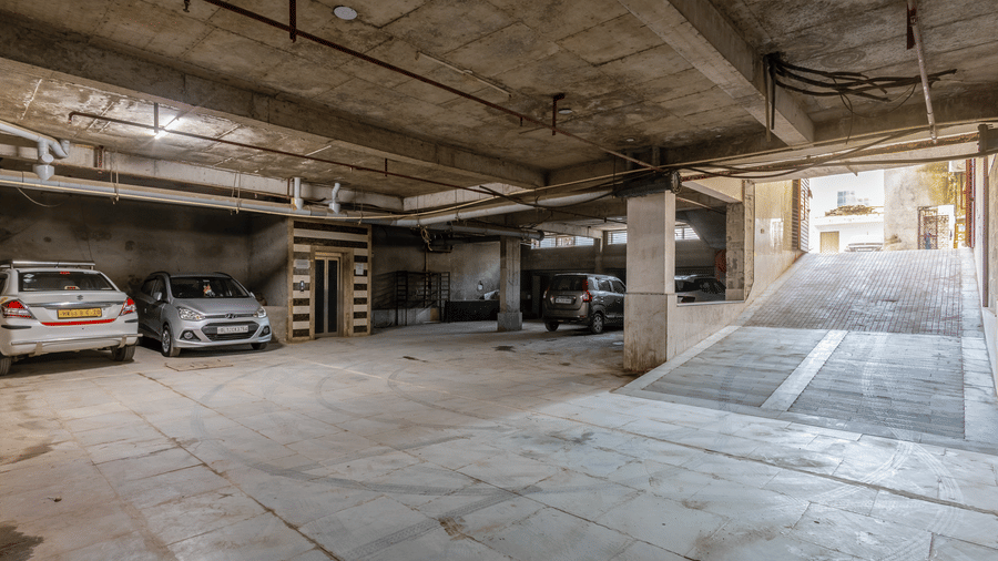 Parking space at Hotel Corporate Suites with designated areas for vehicles and motorbikes