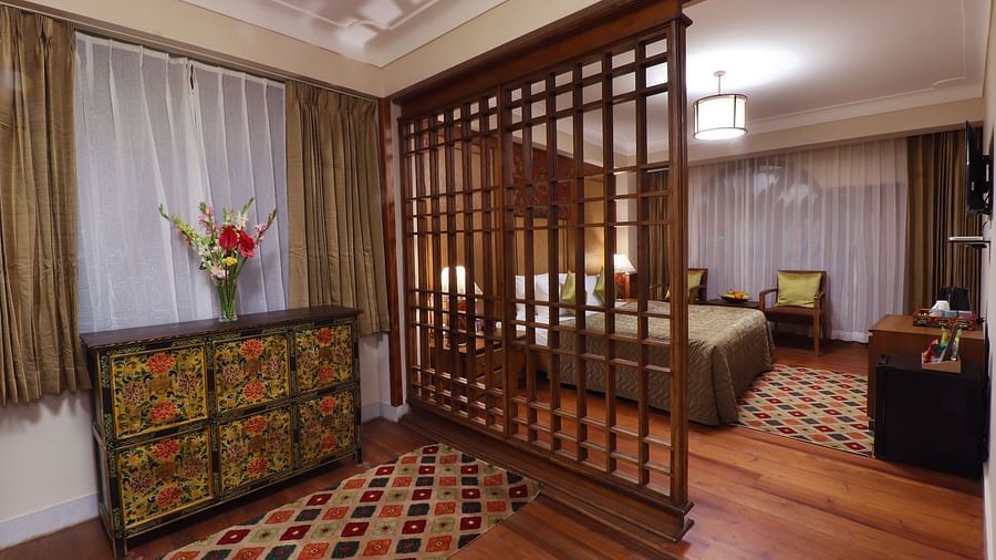 A modern and stylish hotel room with a king-sized bed, a flat-screen TV, and a large window - Hotel Denzong Shangrila Lords Inn 