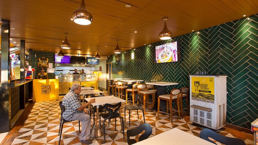 an indoor restaurant with clusters of tables and chairs across the room - Hotel Fountain Tree By TGI - JP Nagar, Bangalore