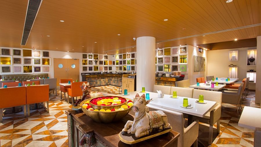 image of a restaurant with clusters of tables and chairs spread across the room - Hotel Fountain Tree By TGI - JP Nagar, Bangalore