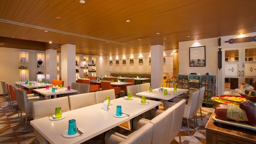 view of a restaurant with rows of rectangular tables with chairs on the long sides - Hotel Fountain Tree By TGI - JP Nagar, Bangalore