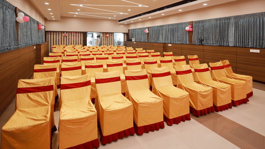 Gangai Hall configured with theatre style seating using gold-covered chairs for conferences and events at Hotel Grand Sabarees Madurai.