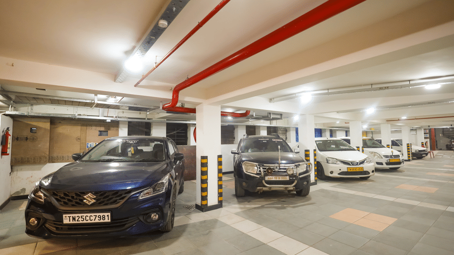 Covered free onsite parking area with cars parked in assigned bays at Hotel Grand Sabarees Madurai.