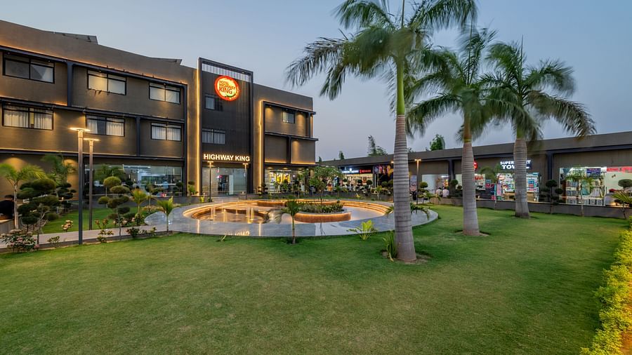 Well-manicured lawn area and a stylish walk way in front of the Hotel Highway King, Behror.