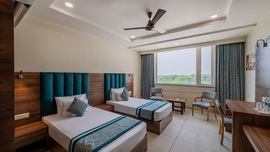 Spacious King Twin Bed Room with window seating, work station, ceiling fan, and modern amenities at Hotel Highway King, Bilaspur.