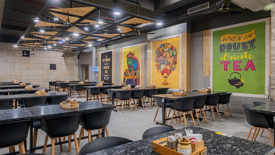 Spacious dining area with vibrant wall murals at Hotel Highway King restaurant.