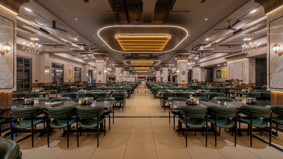 Wide interior view of the expansive dining hall at Highway King Dhodsar featuring rows of dining sets.