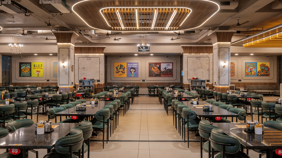Center aisle view of the grand dining hall showing organised seating and modern ceiling fixtures.