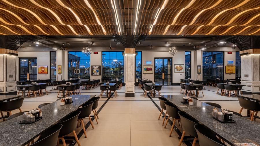 Dining hall with long rows of tables and chairs at Hotel Highway King, Kishangarh restaurant.