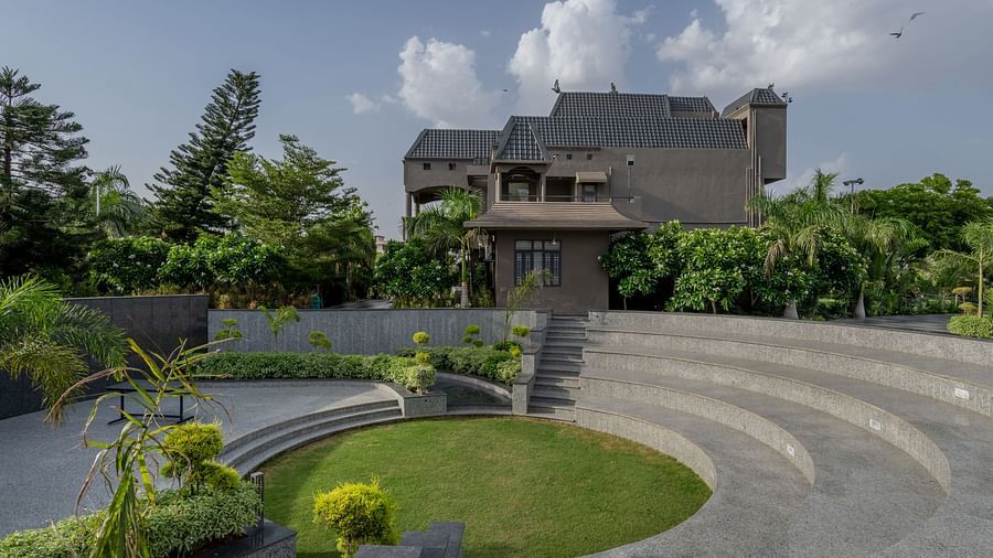 An outdoor event space with tiered seating and a central lawn at Hotel Highway King Shahpura.