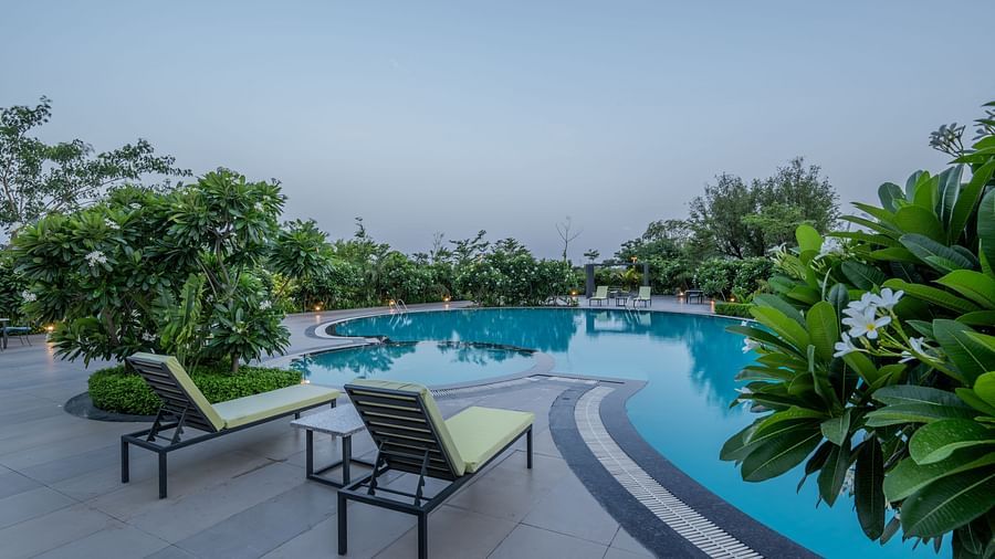 The Hotel Highway King Shahpura swimming pool with lounge chairs on the deck