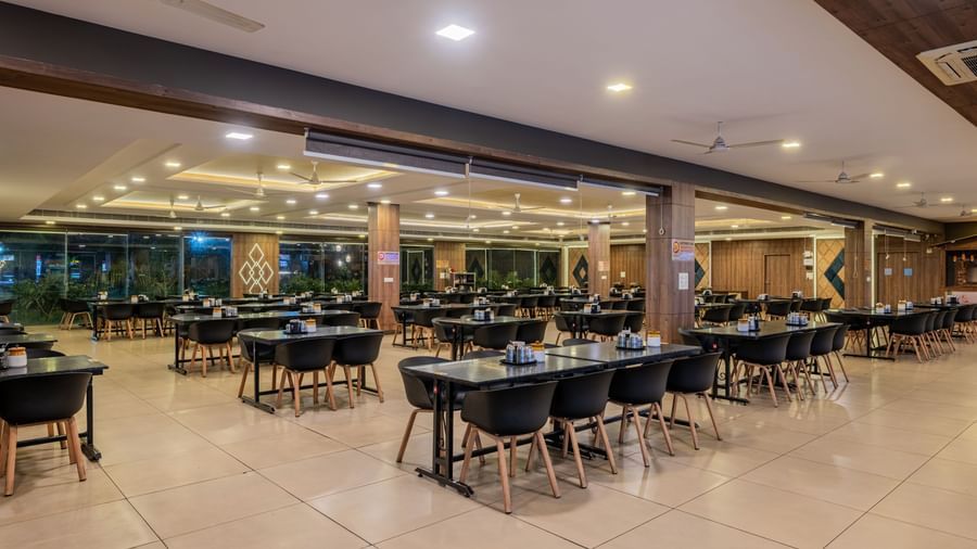 Another view of the spacious and empty restaurant dining area at Hotel Highway King Shahpura.