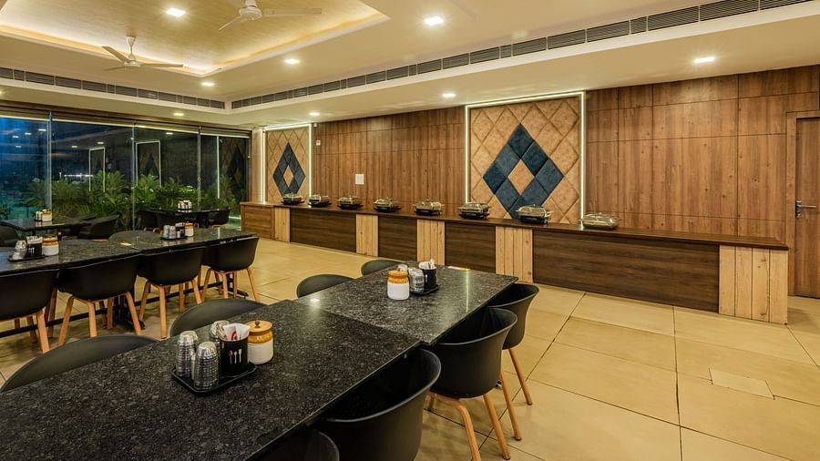 The reception or counter area of Hotel Highway King Shahpura's restaurant, with dining tables visible.