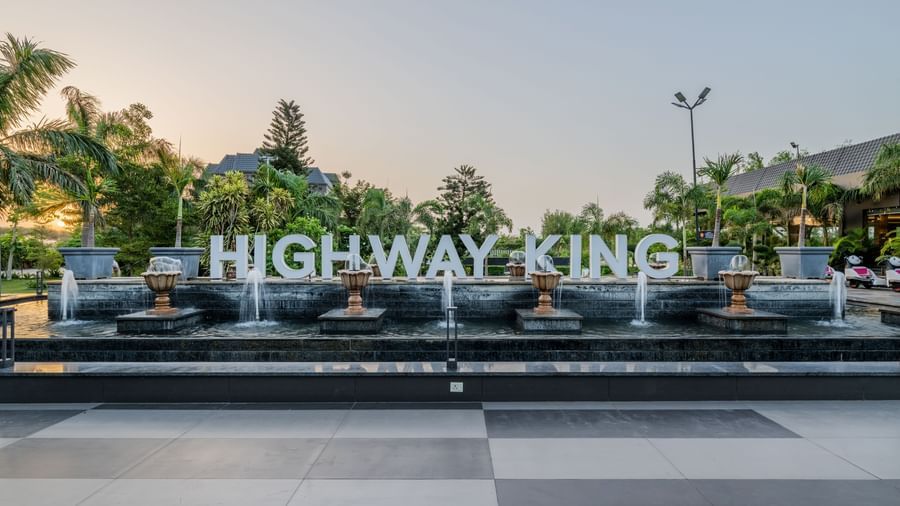 A shot of the signage of Highway king in the lawn of the hotel.