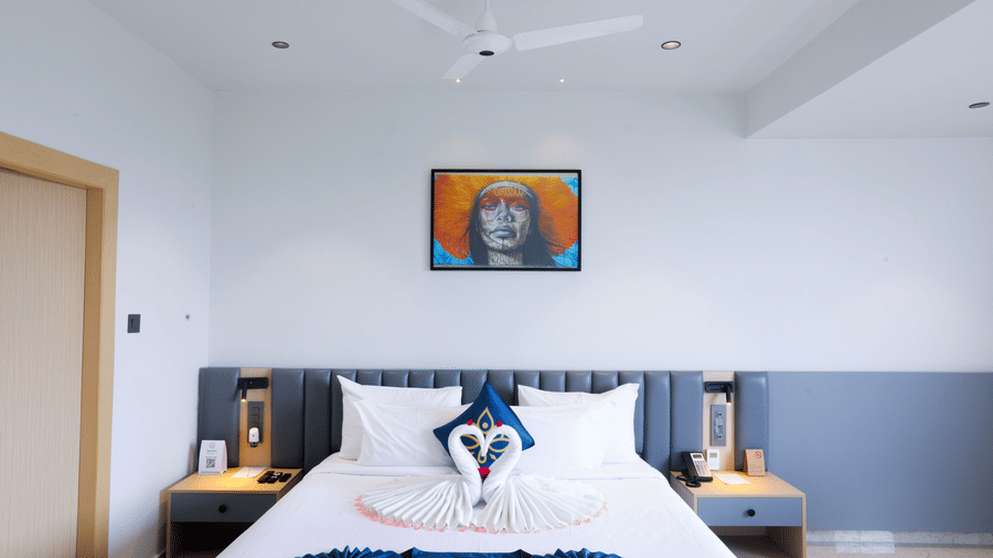 Top-angle view of Luxury Suite king bed with blue décor at Hotel Kyzen HiTech City – Your Zenly Stay.