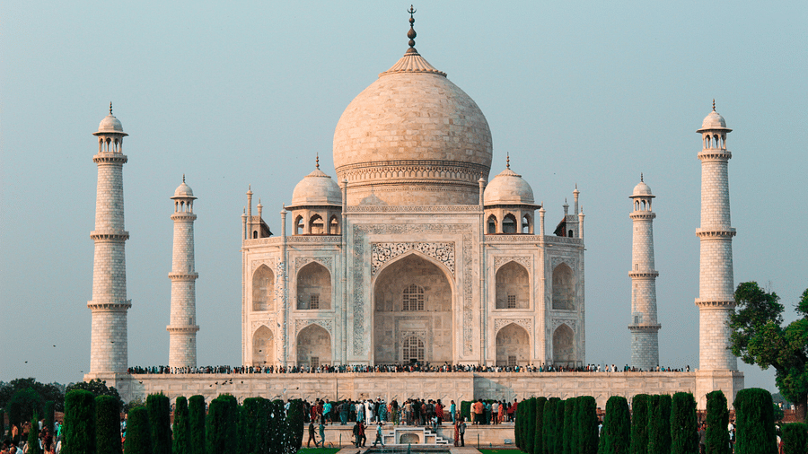 A front wide view of the Taj Mahal in Agra .