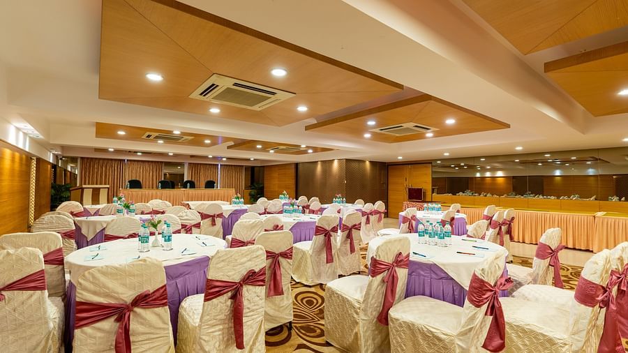 Round table seating arrangements in the banquet hall for an event at Hotel Pai Vista, Mysore