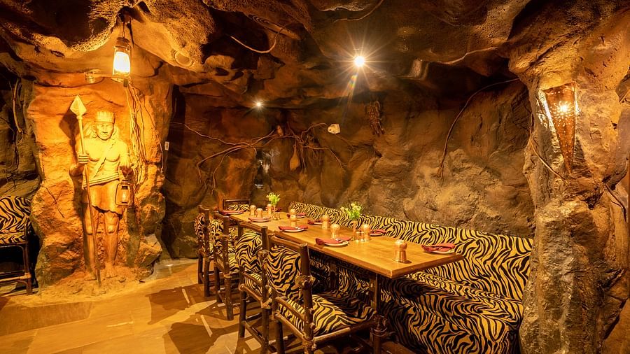 Seating arrangements inside the restaurant with dim lights - Hotel Pai Vista, Mysore