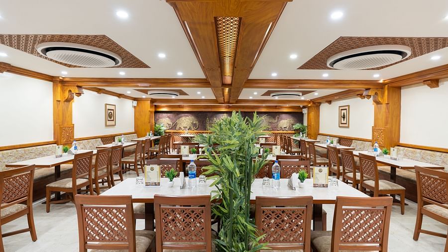 seating arrangements inside the restaurant at Hotel Pai Vista, Mysore